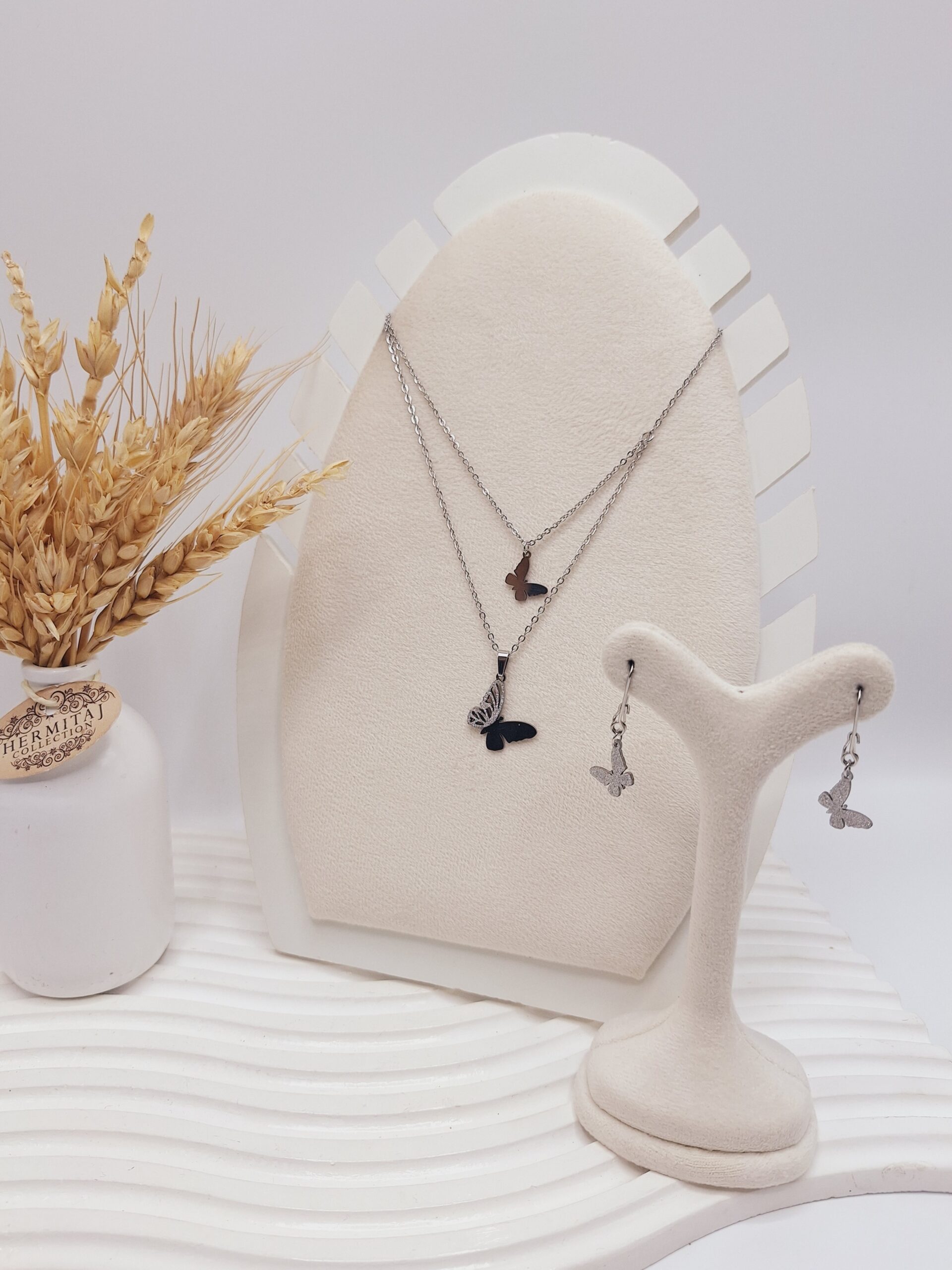 ست گوشواره و گردنبند 2 لاین طرح پروانه مخرج کاری نقره ای استیل