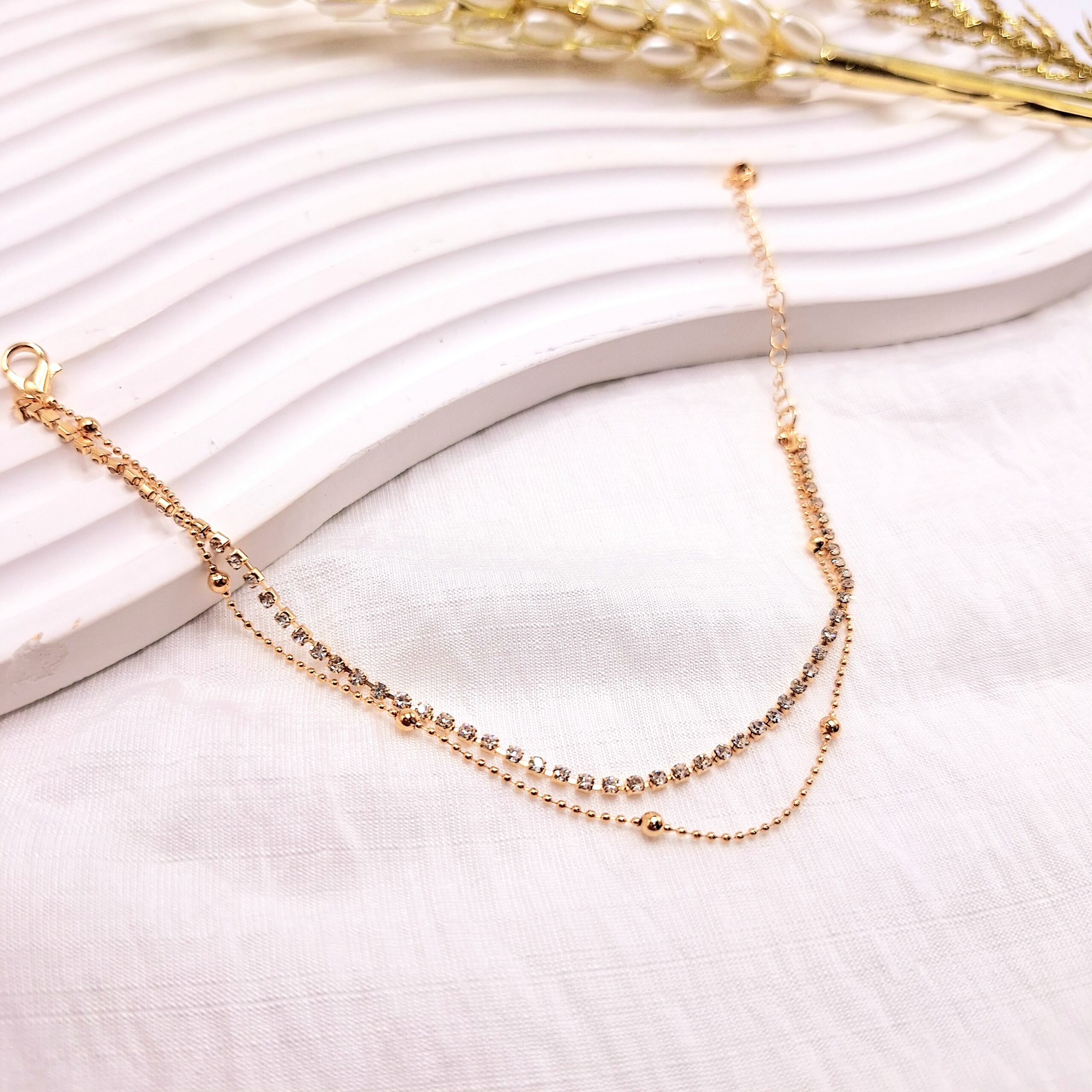 پابند تنیسی نگین دار دو لاین رنگ طلایی