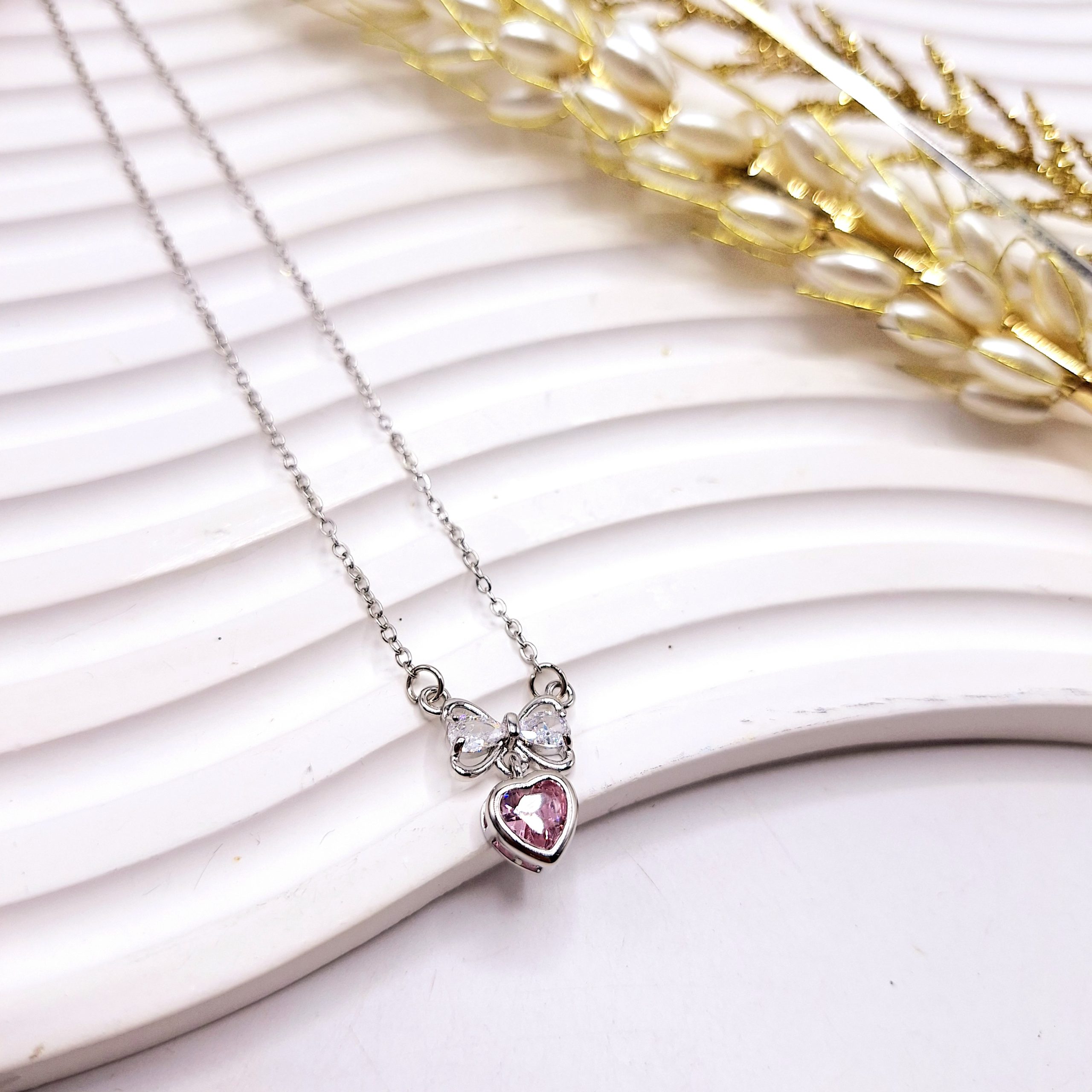 گردنبند زنانه جواهری قلب و پاپیون صورتی استیل