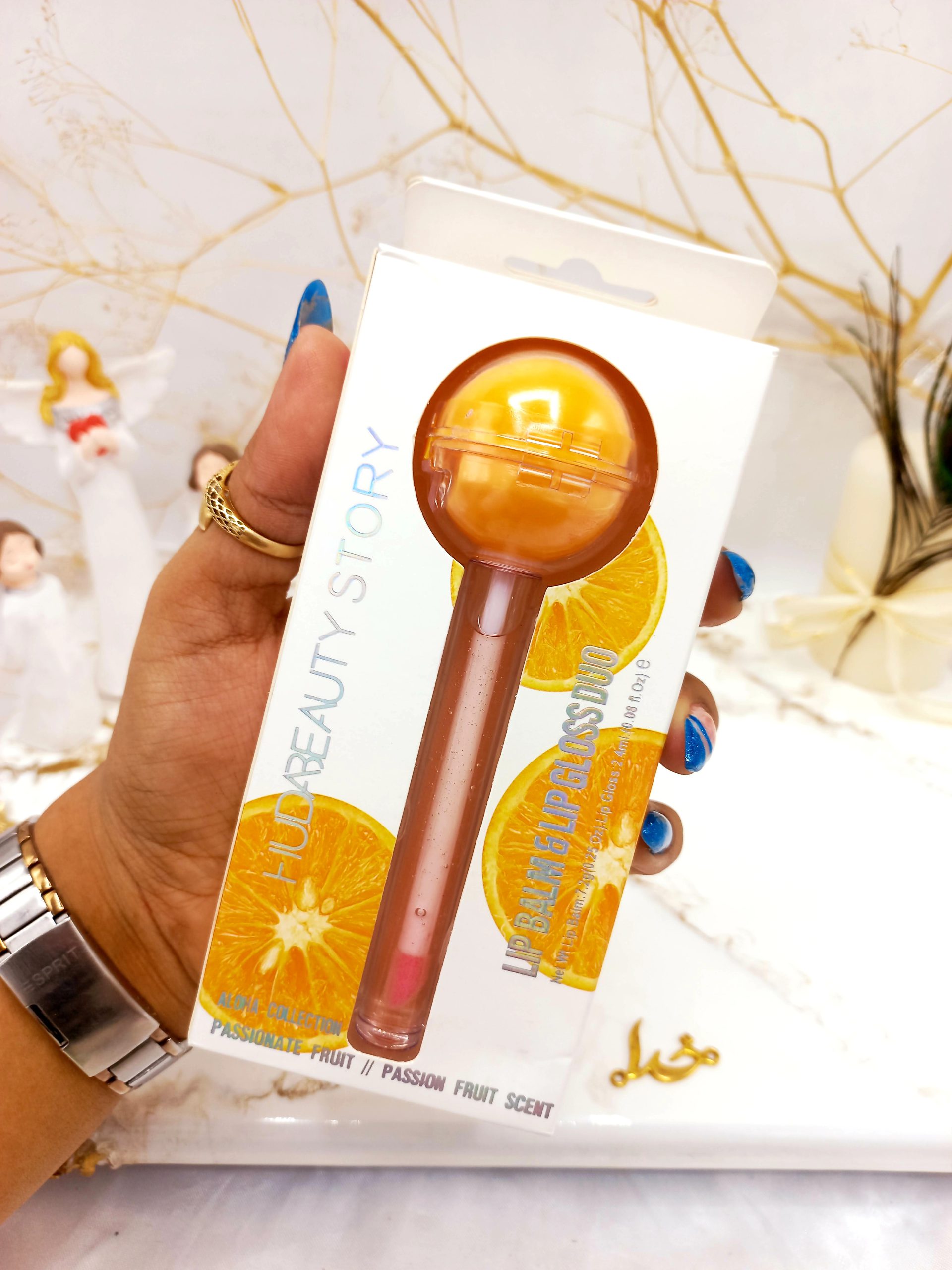برق لب و بالم لب آبنباتی پرتقال هدا بیوتی استوری HUDA BEAUTY STORY