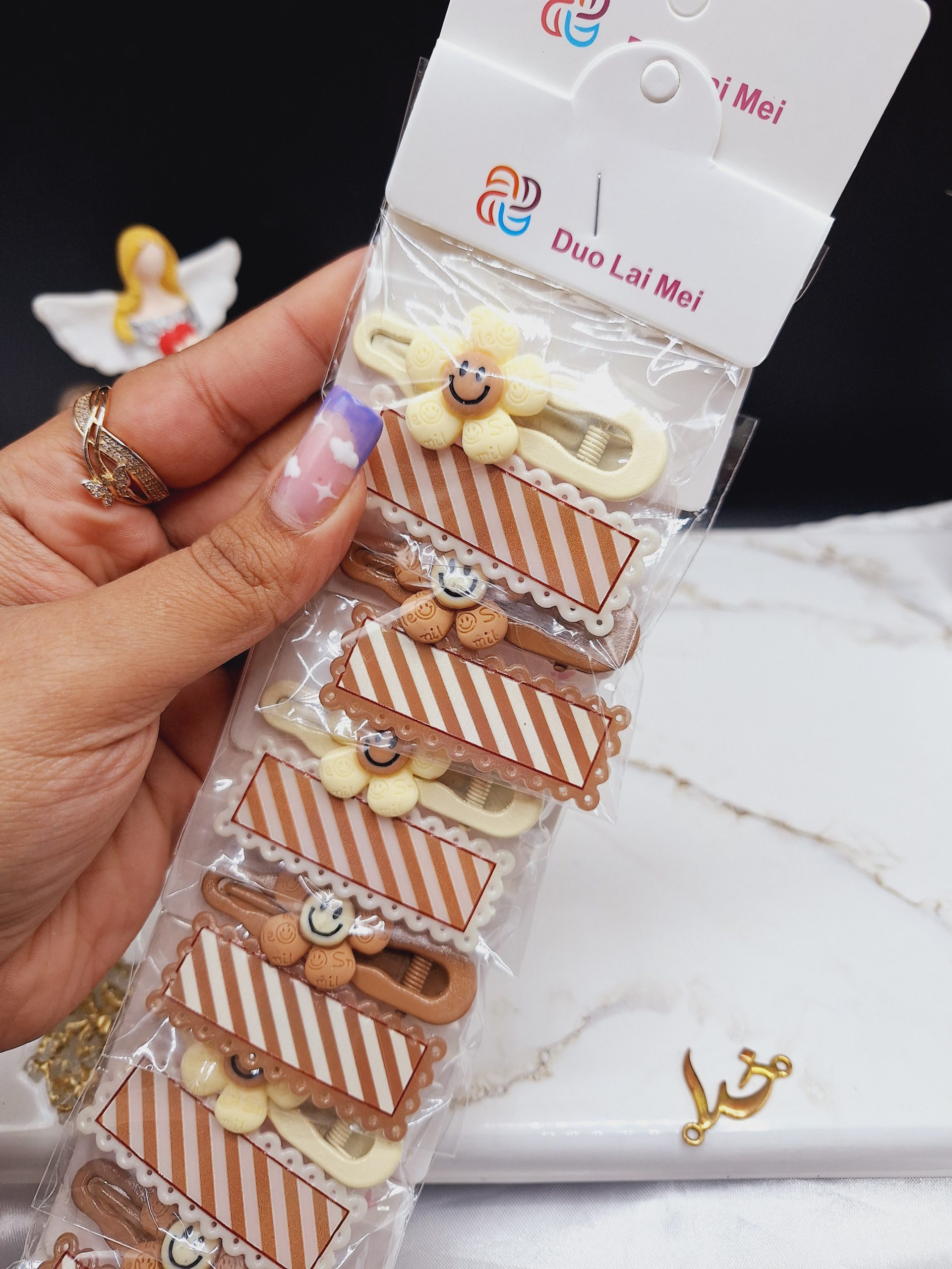 پک 10 عددی پنس و گیره مو نود طرح گل خندان