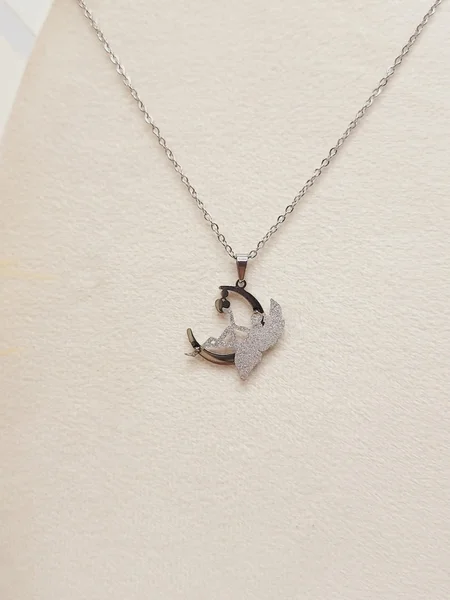 ست گوشواره و گردنبند طرح فرشته و ماه نقره ای استیل